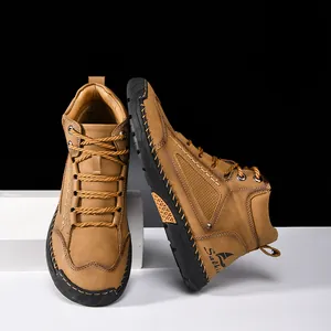 Close-up of hand-stitched detailing and brand logo on men's tan PU leather boots
