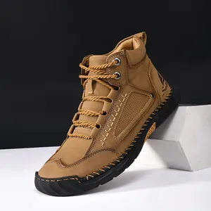 Close-up of handmade stitching and lace-up detail on men's brown leather ankle boots