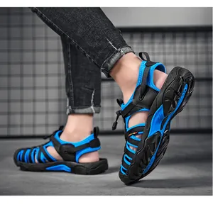 Side view of blue and black outdoor beach sandals with thick anti-slip lug soles and straps