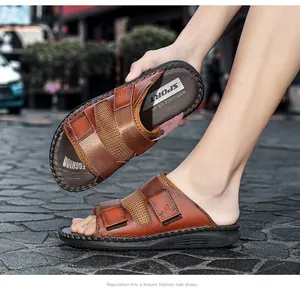 Close-up of brown casual leather sandals with hook and loop straps on a street background
