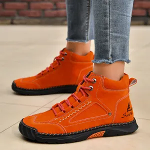 Detailed view of orange PU leather men's ankle boots with hand-stitched details