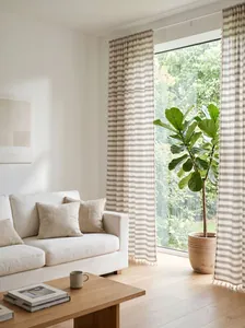 Light French style striped curtains with tassels in a bright modern living room scene