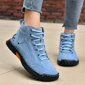 Close-up of men's blue PU leather ankle boots with handmade stitching details