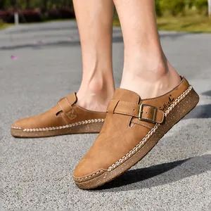 Close-up view of men's brown loafers with buckle and white stitching details