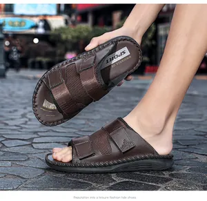 Detailed macro view of brown leather velcro sandals with breathable mesh and logo