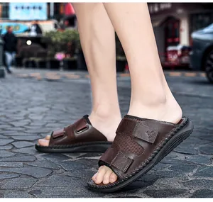Detailed view of brown casual slides with adjustable velcro straps on cobblestone street