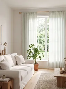 Light green striped curtains with tassel trim in a bright French style living room setting.
