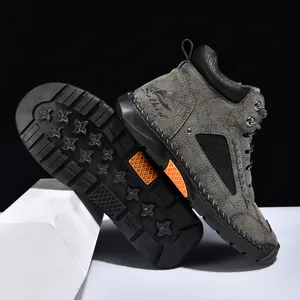 Detail view showing textured grey PU leather and durable non-slip outsole on men's boots