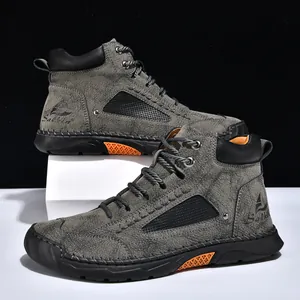 Detail view of men's grey PU leather ankle boots featuring handmade contrast stitching