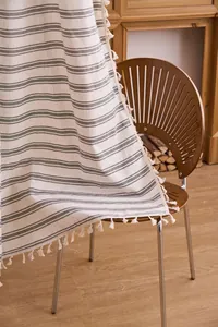 Close-up detail of French green striped sheer curtain with elegant tassel fringe
