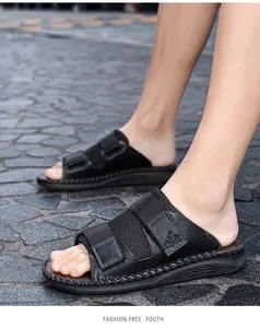 Close-up detail of black adjustable velcro sandals with breathable mesh on stone pavement
