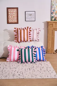 Colorful American style striped ruffle edge cushion covers displayed on a cozy sofa