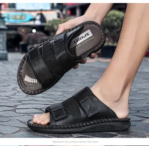 Macro view of black mesh sandals with adjustable velcro straps on stone pavement