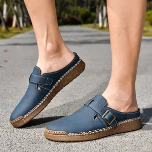 Close-up of men's blue leather loafers with contrast stitching on outdoor path