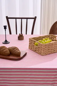 Pink and white striped tablecloth detail with a cozy home dining scene arrangement.