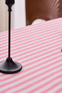 Detailed view of durable pink and white striped fabric texture for dining table cloth.