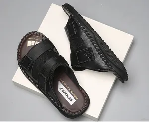 Close-up of black sandals with adjustable velcro straps and mesh detail