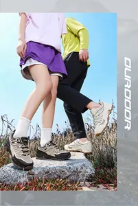 Professional outdoor hiking shoes for men and women shown in a scenic rocky field