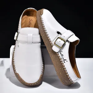 Classic white leather loafers with buckle detail and hand-stitched rubber soles for men and women.