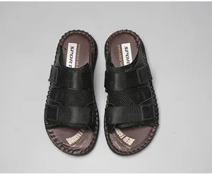 Detailed top view of black sport sandals with velcro straps and brown footbed