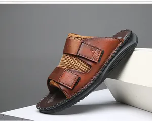 Detail view of brown casual leather sandal featuring adjustable velcro straps and mesh panels