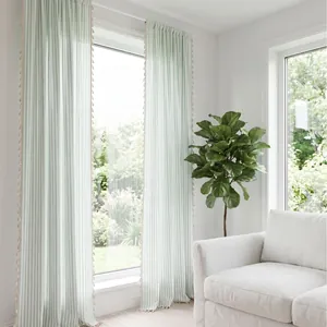 Light French green striped sheer curtains with elegant tassel trim in bright room