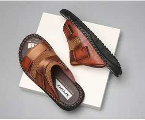 Detailed view of brown casual leather sandals with adjustable velcro straps and mesh design