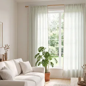 Light French green striped sheer curtains with tassels in a bright minimalist living room