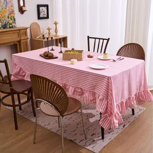 Pink and white striped tablecloth with elegant ruffled edges for indoor dining tables