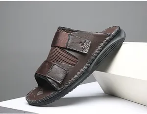 Macro view of brown leather sandals featuring adjustable Velcro straps and mesh details.