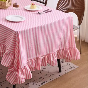 Pink and white striped tablecloth with elegant ruffled edges for dining room decor