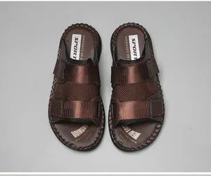 Top view of brown Velcro beach sandals with mesh straps and cushioned soles