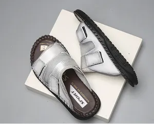 Detailed macro shot of silver sporty sandals featuring triple adjustable velcro straps.