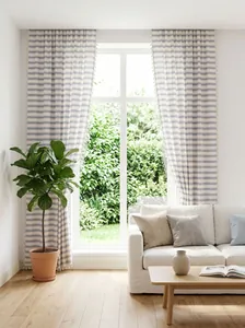 Detailed view of French style navy striped curtains with tassel trim in a bright room