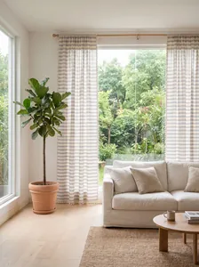 French style navy striped sheer curtains with tassel trim in a living room