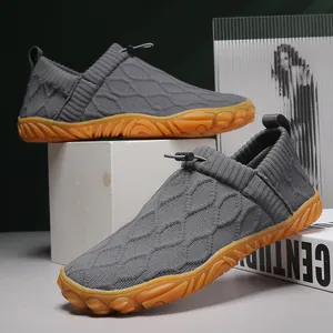 Breathable grey fly-knit casual loafers with durable orange anti-slip rubber soles.