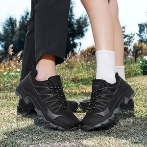 Durable black outdoor hiking shoes for men and women shown on natural grass terrain