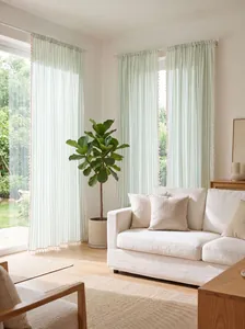 Cozy room scene featuring cream and green striped tassel curtains in soft daylight