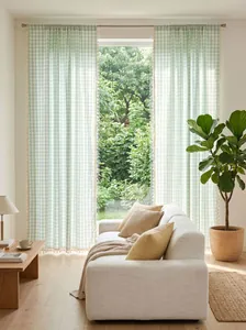 Sage green gingham cotton linen semi-sheer curtains with tassel trim in a sunny room