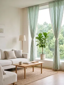 Sage green gingham curtains with handmade tassel trim, seen in a bright living room.
