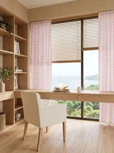 Light French pink striped curtains with lace fringe in a cozy home study with sea view