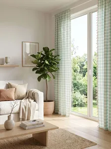 Sage green plaid cotton linen curtain with tassel fringe in a bright airy living room