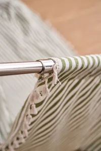 Primer plano de una cortina de rayas verdes de estilo francés con borlas decorativas
