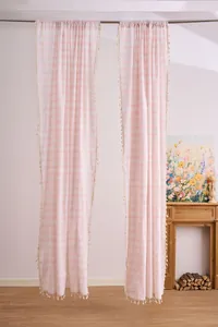 Elegant pink striped fabric curtains with decorative tassel edges in French country style
