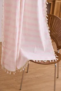Close-up of pink striped sheer curtain featuring delicate tassel fringe edges