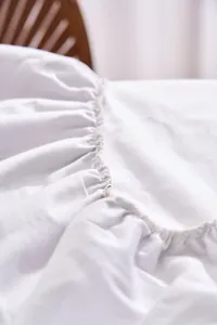 Close-up of the elegant white ruffled flannel tablecloth edge for outdoor wedding banquets