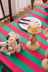 Detailed view of red and green striped velvet tablecloth with elegant ruffled edge decoration