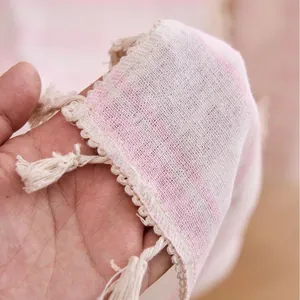 Elegant pink and white striped sheer curtain with delicate lace trim and tassels.