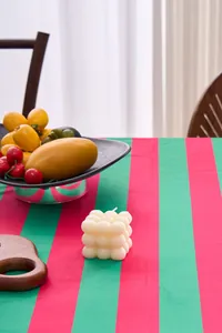 Festive red and green striped velvet tablecloth displayed in a dining setting