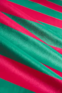 Close-up macro view of the two-color striped velvet fabric showing texture and sheen